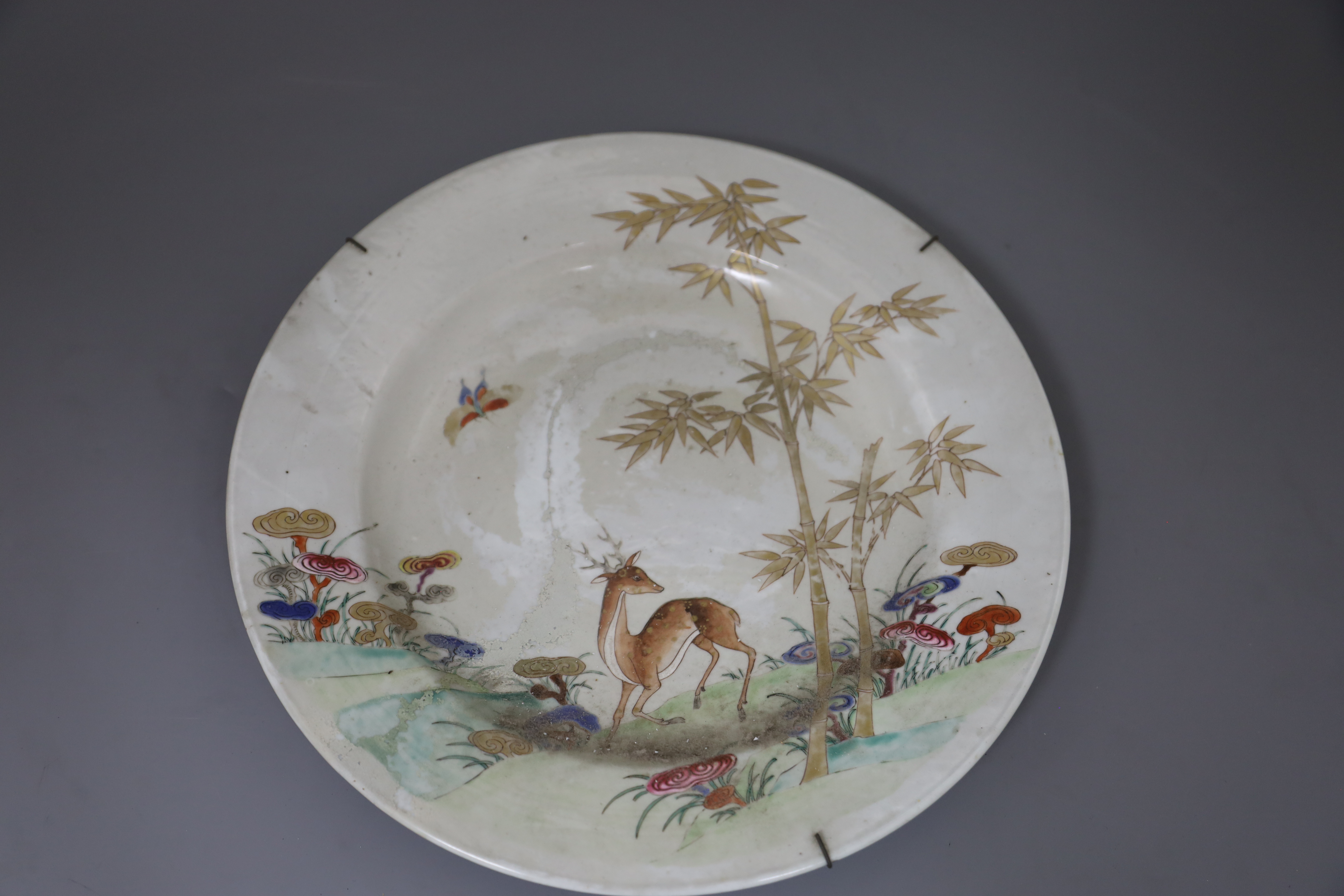 Three graduated Chinese famille rose deer, bamboo and lingzhi dishes, Qianlong period (1736-95), D. 26cm, 32cm and 38.5cm